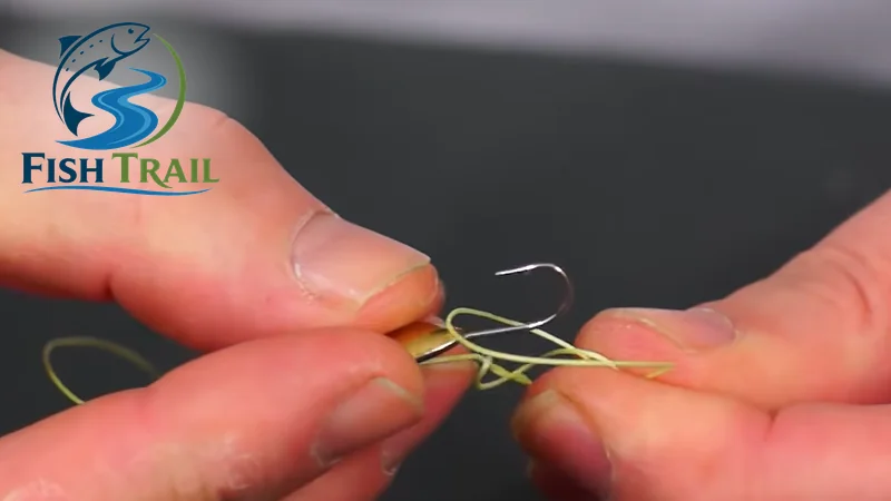 Placing the clinch knot loop over the hook shank of a through-body mormyshka