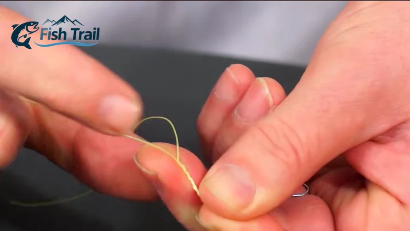 Forming a loop and wrapping fishing line to tie a clinch knot on an eyed mormyshka