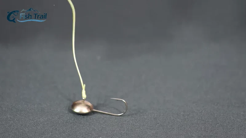 Two mormyshkas tied to fishing line with clinch knots, showing eyed and through-body designs